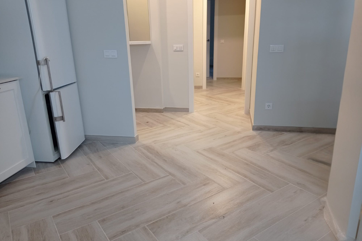 Suelo porcelánico imitación madera colocado en espiga en salón en el Maresme